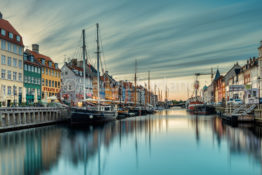 A couple of drunk men were searching for the ferry to Poland while I was shooting photos here by the calm waters in the old canal of Nyhavn, Copenhagen. The sun rises behind the old houses, giving a soft light.